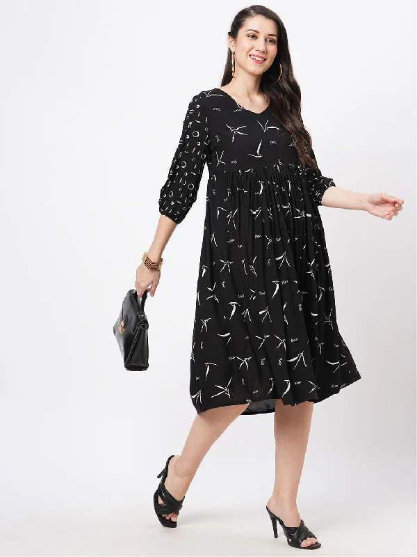 Hashtag Be Featuring a wide black dress with gathers and sleeves in complimenting print Tunics Brand named